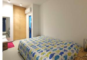 a bedroom with a bed with a blue and yellow comforter at San Mark's basin best view in Venice