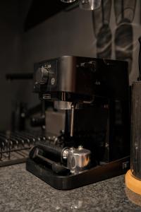 a black coffee maker sitting on top of a stove at INFINITY I Seventharts I Cinema room in Angoulême
