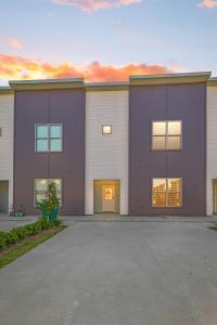 a large building with a parking lot in front of it at NEW-Upscale-EnSuites-King Bds-Fast WiFi-Quiet Area in Youngsville