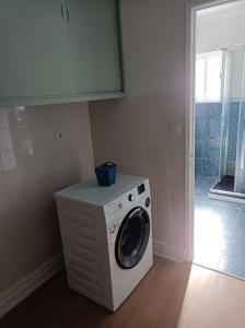 a washer and dryer sitting in a room at Cantinho da Cruz in Ponta Delgada
