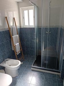 a bathroom with a shower and a toilet at Cantinho da Cruz in Ponta Delgada +6 photos