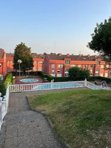 a fence in front of a yard with buildings at Chalet en Costa Quebrada - Soto de la Marina in Santa Cruz de Bezana