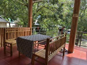 a table and chairs on the porch of a house at Ume Homestay in Mai Châu