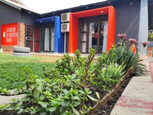 a building with a bunch of plants in front of it at Stofberg Guest House in Brits