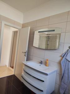 a bathroom with a sink and a mirror at Apartments Marija in Trogir +46 photos