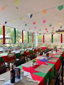 a dining room with tables with red and green tablecloths at Get a Flat 405 Noble-Jardins Neighborhood - SP in Sao Paulo