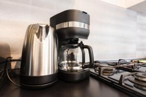 a coffee maker sitting on top of a stove at Appartement dans un charmant village avec parking in Sevremont