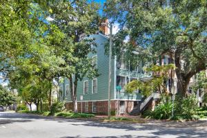 a green house on the side of a street at Mint Julep Estate in Savannah
