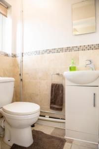 a bathroom with a toilet and a sink at 70 Abbotsbury Road, Bury St Edmunds, IP33 2HP in Moffat +18 photos