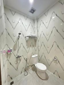 a bathroom with a toilet in a room at Hotel Dotaga in Malinau +13 photos