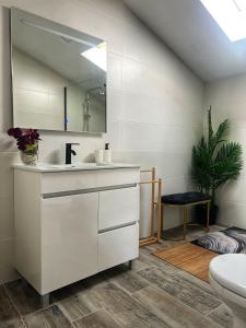 a bathroom with a sink and a mirror at Cantinho D'Amy in Arcos de Valdevez