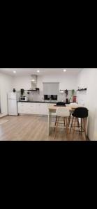 a kitchen with a table and chairs in a room at Cantinho D'Amy in Arcos de Valdevez