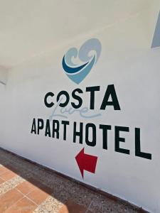 a sign for a port hotel on a wall at Costa Love Hotel Aeropuerto in Punta Cana
