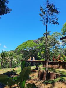 a wooden bridge with a mountain in the background at Casa Arco-Iris in Itacaré