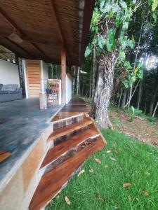 a wooden bench in front of a tree at Casa Arco-Iris in Itacaré +54 photos