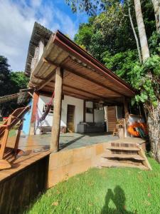 a house with a porch with a roof at Casa Arco-Iris in Itacaré