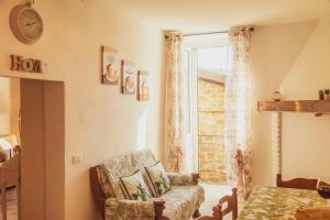 a living room with a chair and a window at Little House near Bevagna for Wine & Italian Culture in Limigiano
