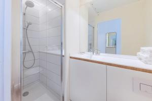 a white bathroom with a shower and a sink at The Babel Community - République - Joliette in Marseille