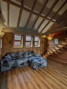 a bedroom with a bed in a room with wooden floors at Villa Atypique - Charme & Confort in Le Moule