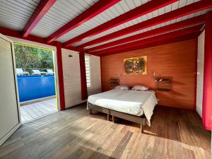 a bedroom with a bed in the middle of a room at Villa Atypique - Charme & Confort in Le Moule +50 photos