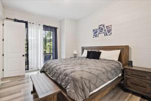 a bedroom with a large bed and a window at Smoky Shores Lakeview Cabin By Beyond Expectations in Sandy Ridge