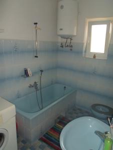 een badkamer met een bad, een toilet en een wastafel bij Beautiful sea view in Senj