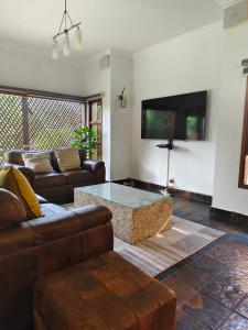 a living room with a couch and a coffee table at Forest Crescent Villa - Pecanwood Golf Estate, Hartbeespoort in Hartbeespoort