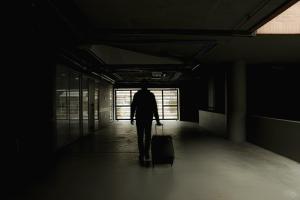 a man walking down a hallway with a suitcase at Hemma Bogotá Chapinero Premium Suites Hotel in Bogotá +39 photos