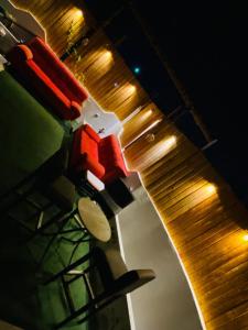 a kitchen counter with a wooden cutting board and lights at rooz Hotel apartments in Aqaba