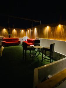 a patio with a table and chairs at night at rooz Hotel apartments in Aqaba