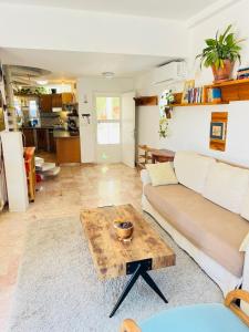 a living room with a couch and a table at the boat house in Zikhron Ya'akov