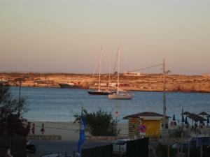two boats in a body of water with a harbor at Casa alla Guitgia 2 in Lampedusa