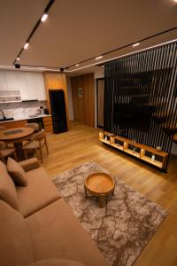 a living room with a couch and a large television at Lakeside Villas in Široka