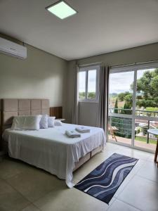 卡洛斯-巴尔博萨Palafita's的一间卧室，配有一张大床和一扇大窗户。