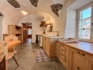 a kitchen with wooden cabinets and a sink and a table at Apartment Dolavilla in Canazei