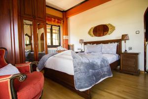 a bedroom with a large bed and a chair at Villa Tethys Mountain Resort in Zákas