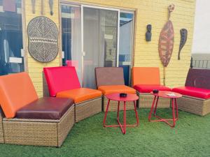 a group of chairs and tables in front of a building at Banana Bungalow West Hollywood Hotel & Hostel in Los Angeles