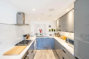 a kitchen with white counters and a stove top oven at The Merchants House in Pittenweem