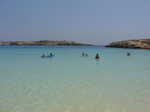 a group of people in the water at a beach at Casa alla Guitgia 2 in Lampedusa