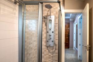 a shower in a bathroom with a tile wall at Frente al mar y a pie de playa in Torrenueva