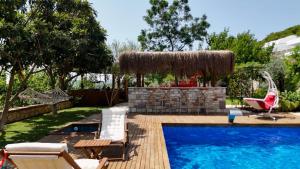 a pool with chairs and a bar next to a resort at Casa del Olivia in Seferihisar