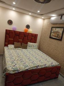 a bedroom with a large bed with balloons on the wall at One bed apartment in Lahore in Lahore