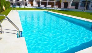 a swimming pool with blue water in a building at COSTA TROPICAL & ALPUJARRAS Relaxation in Vélez de Benaudalla