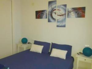 a bedroom with a blue bed with two pillows at COSTA TROPICAL & ALPUJARRAS Relaxation in Vélez de Benaudalla +10 photos