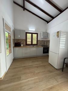 a kitchen with white appliances and a white refrigerator at Villa Soussoute - à 2mn de la plage de Tartane in La Trinité