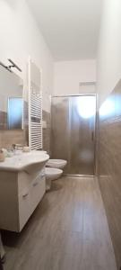 a bathroom with two sinks and a shower and two toilets at Ali Blu bed and breakfast in Uggiano la Chiesa