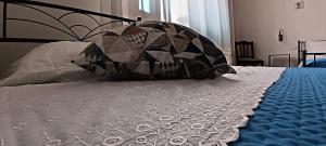 a bed with a pillow on top of it at Ali Blu bed and breakfast in Uggiano la Chiesa +2 photos