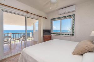 a bedroom with a bed and a view of the ocean at Casa del Mar in Akumal +34 photos
