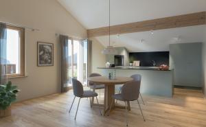 a kitchen and dining room with a table and chairs at Tgesa Romana in Savognin