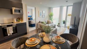 a kitchen and living room with a table and chairs at old in Manchester